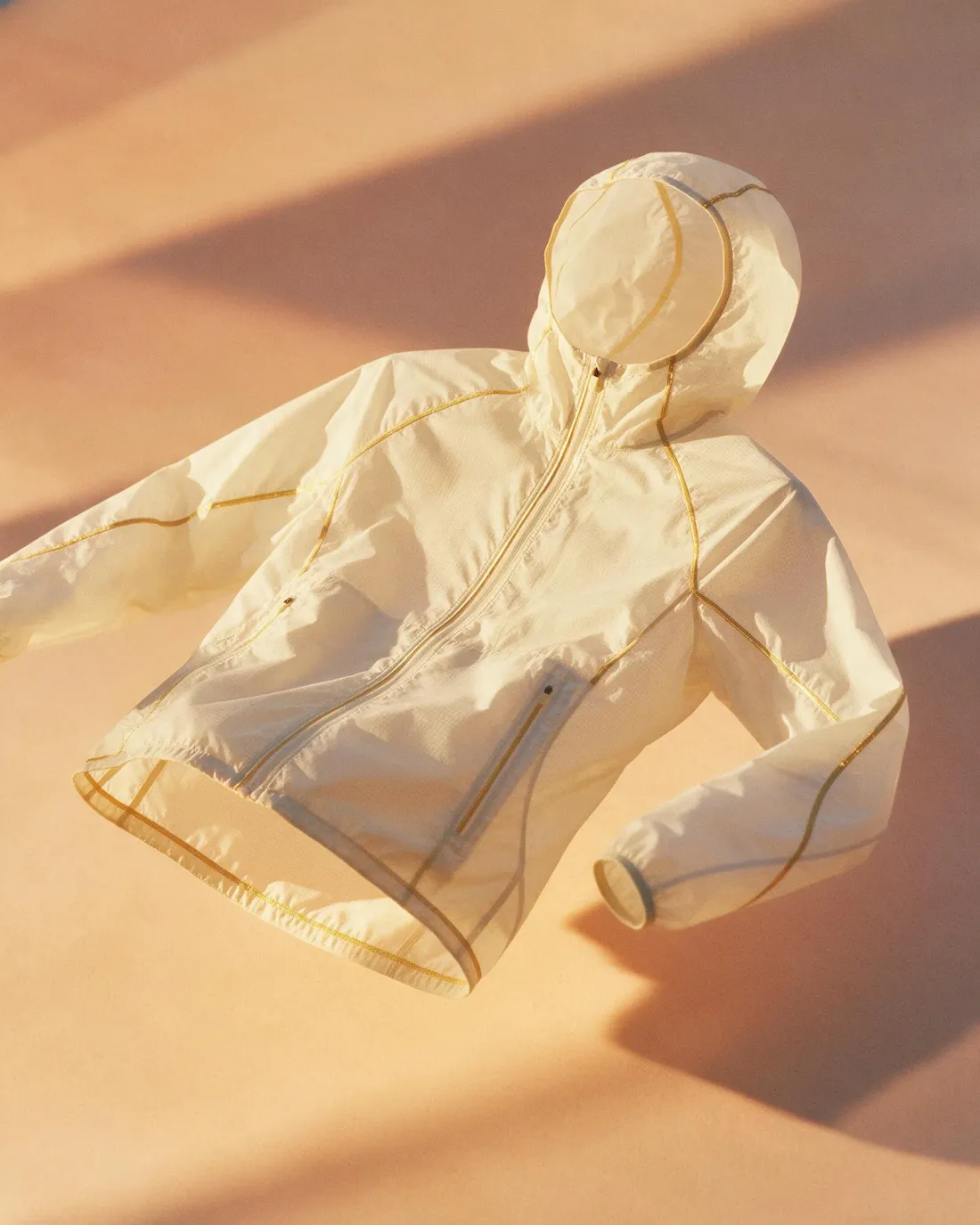 Vesper shell jacket, product still on a peach seamless, generated by Starwish with Seedream 5.0 Pro